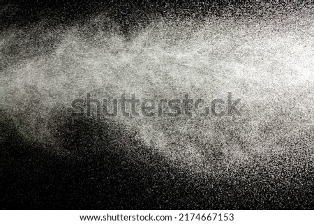 Sprayed water. Small droplets of water in the air. Lots of water drops, isolated on black background. Royalty-Free Stock Photo #2174667153