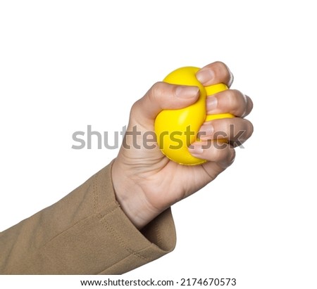 Woman squeezing antistress ball on white background, closeup Royalty-Free Stock Photo #2174670573