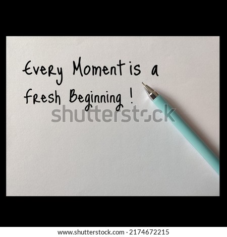 motivational quote written on a paper with pen background every moment is a fresh begining
