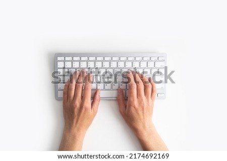 Female hands on the keyboard on a white background. Top view, flat lay. Royalty-Free Stock Photo #2174692169