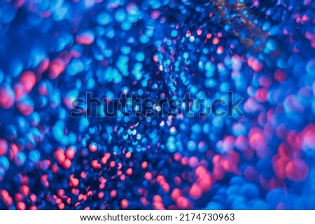 Neon bokeh glow. Fluorescent abstract background. Cyber illumination. Defocused navy blue pink color circles light flare futuristic texture.