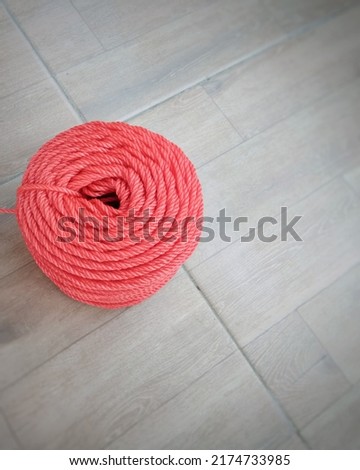 Plastic ropes. Looks like a roll of woolen thread for warm fabric