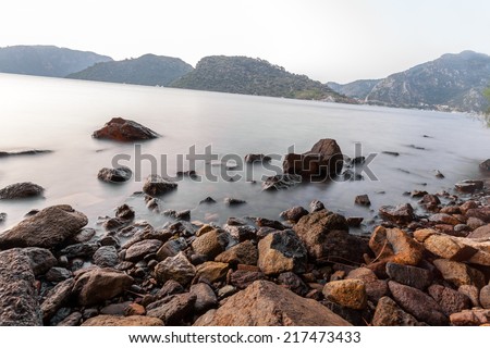 Stones on a background of blurred sea with mountain views 