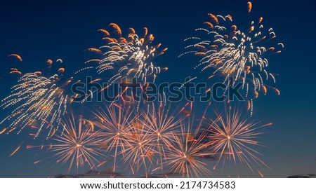 Fireworks light up the sky with dazzling display. Abstract colored firework background with free space for text. Long exposure.