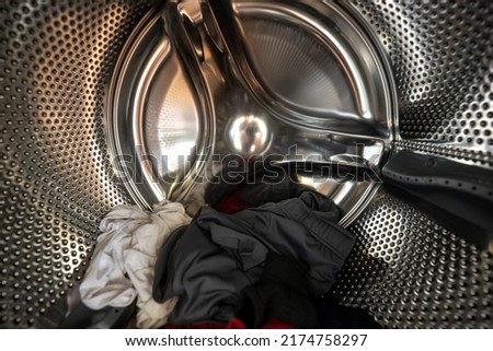 Inside of a Washing Machine with Clothes Royalty-Free Stock Photo #2174758297