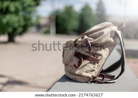 Travel concept. Vintage hipster backpack. Summer city street