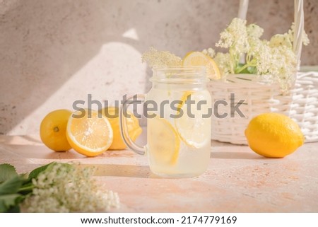 Homemade elderflower lemonade with lemon juice and freshly picked elderberry flowers. Healthy refreshing mocktail with elderflower cordial syrup. Healthy summertime drinks
