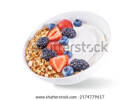 Fresh breakfast with greek yogurt nuts oatmeal granola with berries in a bowl on a white isolated background. the toning. selective focus Royalty-Free Stock Photo #2174779617