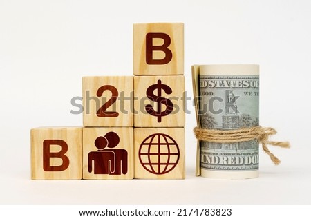 Business concept. On a white surface, dollars and cubes with images and the inscription - B2B