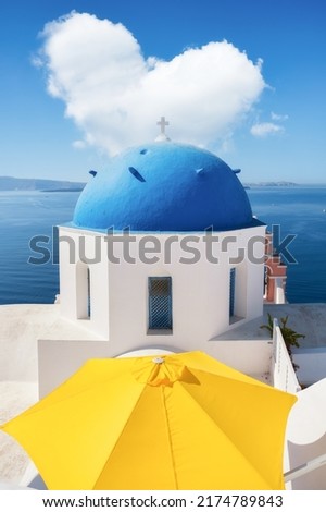 Oia village, Santorini Island, Greece. A cloud in the shape of a heart. A blue sky and a heart sign. Travel and vacation photography.