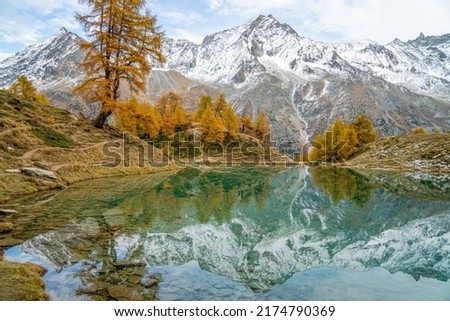 Wonderful Golden Autumn Day at the Blue Lake "Lac Bleu" in Arolla Valais Switzerland Royalty-Free Stock Photo #2174790369