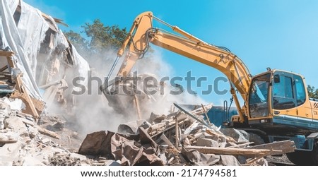 Demolition building. Excavator destroy old house Royalty-Free Stock Photo #2174794581
