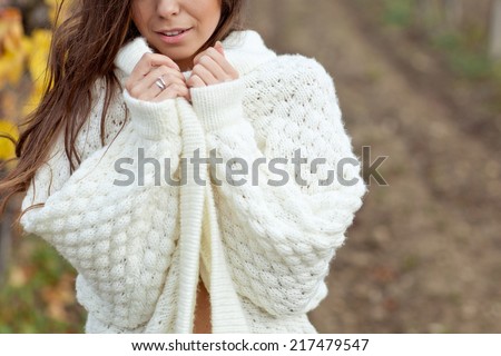 Beautiful woman in a sweater in the fall Royalty-Free Stock Photo #217479547