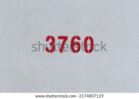 Red Number 3760 on the white wall. Spray paint.
