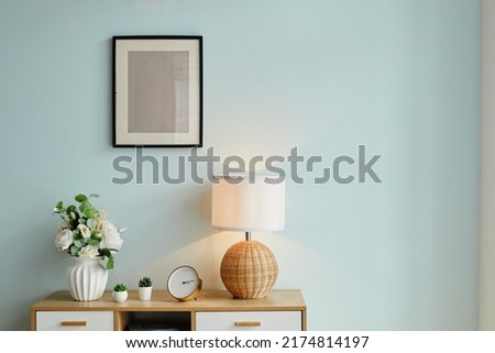 Background image of minimal home decor with flowers and mock up picture on wall, copy space