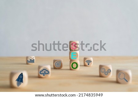 Search engine optimization concept. A cube-shaped wooden block sits on a desk with the word SEO.