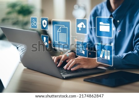Businessman using a computer to document management concept, online documentation database and digital file storage system software, records keeping, database technology, file access, doc sharing. Royalty-Free Stock Photo #2174862847