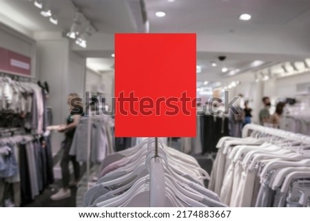 Red empty tag for mock up with space for advertising or price information indoor of clothes store