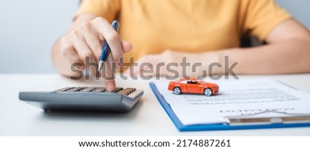 Woman using calculator during signing contract document. buy and sale, insurance, rental and contract agreement concepts