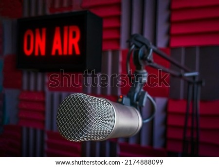 Professional microphone in radio station studio and on air sign Royalty-Free Stock Photo #2174888099