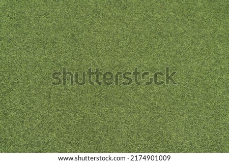 Artificial green grass in wallpaper or background 