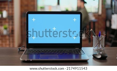 Empty office desk with greenscreen display on wireless laptop, used by employees at corporate job. Blank chroma key background with isolated copyspace template and mockup screen.