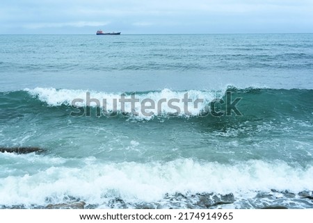 Nature background with sea waves hitting the sea shore. Scenic view of sea against cloudy sky