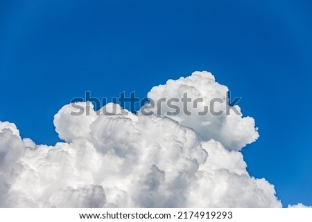 Photography of beautiful storm clouds, cumulus clouds or cumulonimbus against a clear blue sky. Full frame, sky only.