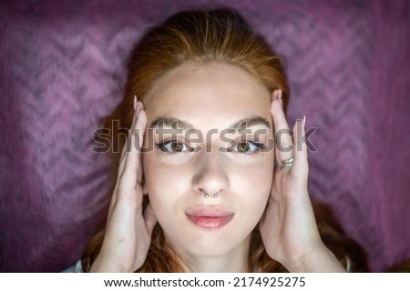 Young woman with beautiful eyebrows after procedure permanent make-up in salon. High quality photo