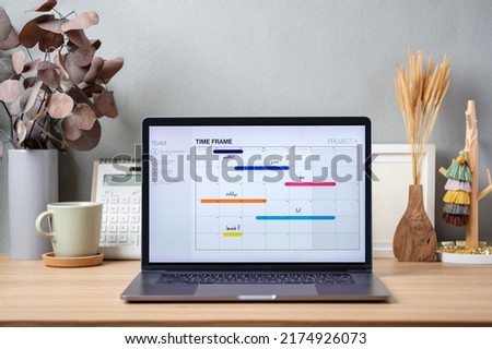 timetable project on screen laptop on working desk decor with stationery at home