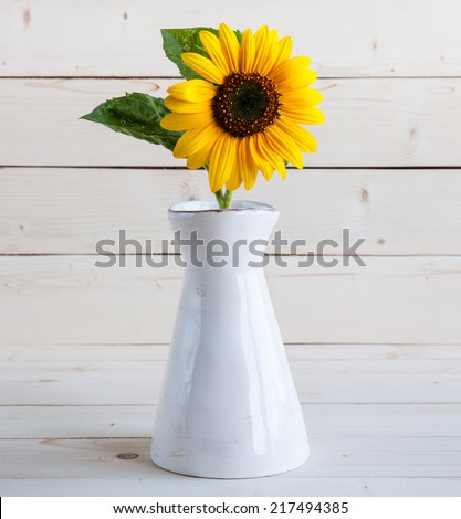 Sunflowers in a vase on a rustic, gray background