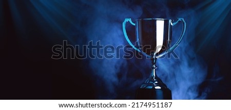 Silver Trophy award competition with smoke in the dark , Blue Tone Royalty-Free Stock Photo #2174951187