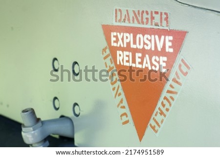 Danger Explosive Release, aircraft warning decal or sign on an old jet fighter airplane