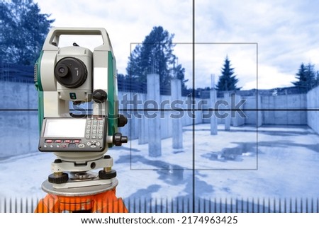 Geodetic instrument. Optical theodolite in front of building under construction. Geodetic device next to foundation. Topographic surveys during construction. Equipment geodetic sale. Surveyor device Royalty-Free Stock Photo #2174963425