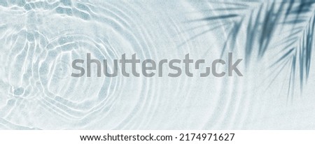 palm leaf shadow on abstract white sand beach background, sun lights on water surface, beautiful abstract background concept banner for summer vacation at the beach Royalty-Free Stock Photo #2174971627