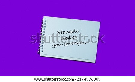 Handwriting notes struggle makes you stronger quotes notebook. lifestyle, advice, support motivational positive words are written on a wooden background. Business, signs, quotes, symbols, concepts.