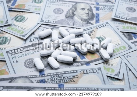 Pills on the background of the dollar close-up.