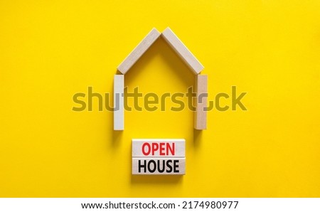 Open house symbol. Concept words 'Open house' on wooden blocks near miniature house. Beautiful yellow background, copy space. Business and open house concept.