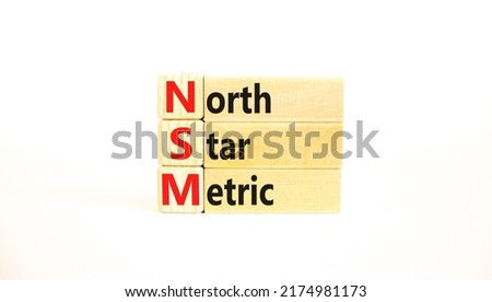 NSM north star metric symbol. Concept words NSM north star metric on wooden blocks on a beautiful white background. Business and NSM north star metric concept. Copy space.