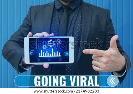 Handwriting text Going Viral. Business showcase image video or link that spreads rapidly through population Man holding Screen Of Mobile Phone Showing The Futuristic Technology.