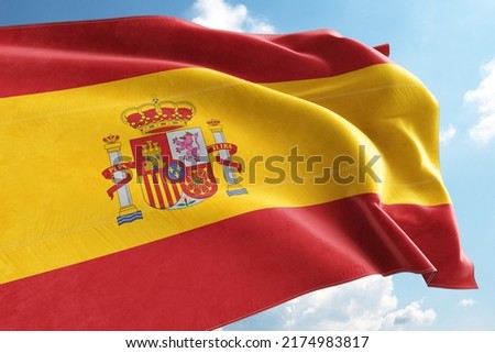 Spain Flag Waving in the Wind on Flagpole, on sky background Royalty-Free Stock Photo #2174983817