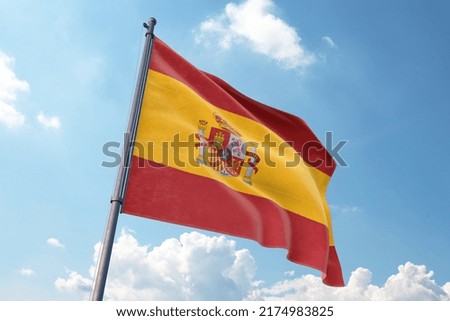 Spain Flag Waving in the Wind on Flagpole, on sky background Royalty-Free Stock Photo #2174983825