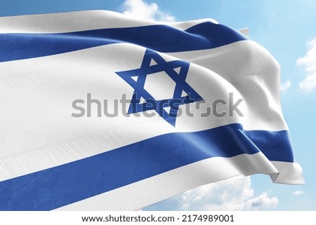 Israel Flag Waving in the Wind on Flagpole, on sky background Royalty-Free Stock Photo #2174989001