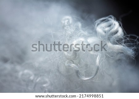 Extreme macro of polyester stable fiber. Selective focus, shallow depth of field. Royalty-Free Stock Photo #2174998851