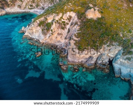 a wonderfully clear sea of color and a rocky shore view
