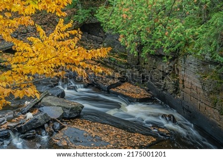 Autumn landscape of the Sturgeon River rapids captured with motion blur, Michigan's Upper Peninsula, USA 