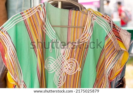 Beautiful handmade tunic dresses from Morocco at an outdoor market Royalty-Free Stock Photo #2175025879