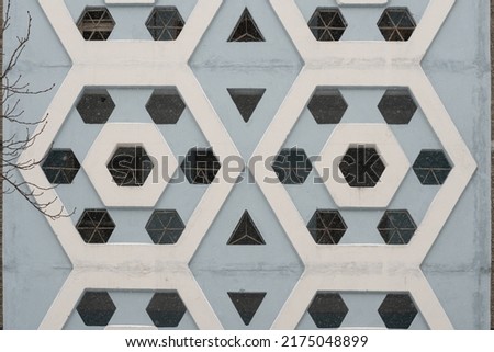 Decorative concrete shabby wall of the house in the style of Soviet modernism. Royalty-Free Stock Photo #2175048899