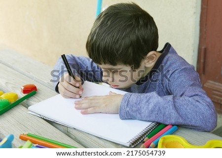 Child boy have drawing outdoor