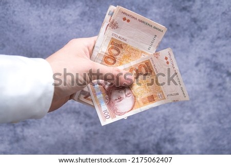 close-up of 100 kuna (HRK) banknotes held in hand. Croatian economy and business Royalty-Free Stock Photo #2175062407